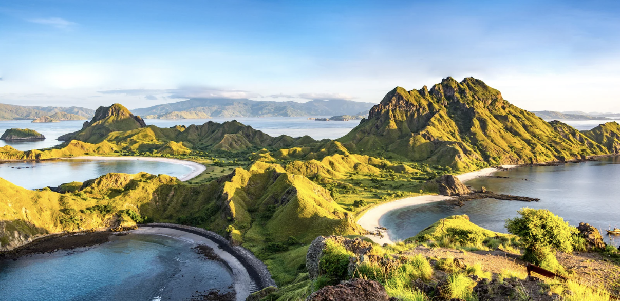 Padar Island in the wet season, its hills turned green above three sandy bays