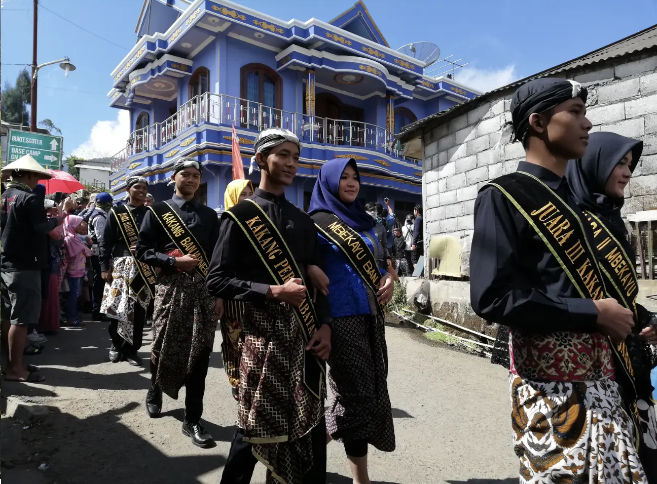 Cultural procession at Dieng Culture Festival, participants in Javanese dress along the village road